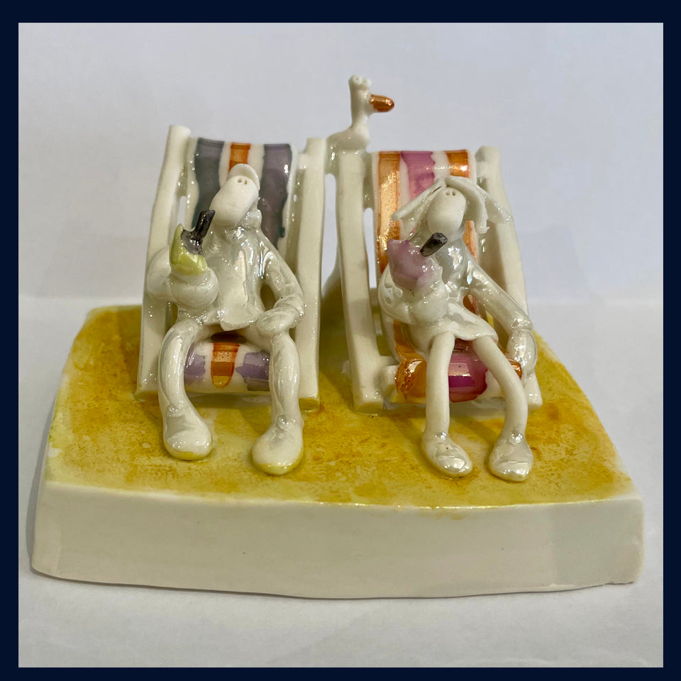 Ceramic Miniaturist Andrew Bull - couple sat on deckchairs on the beach