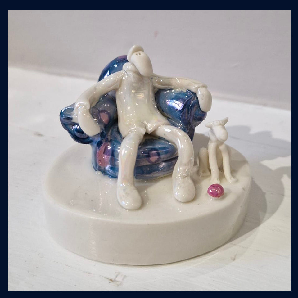 Ceramic Miniaturist Andrew Bull - armchair man with dog