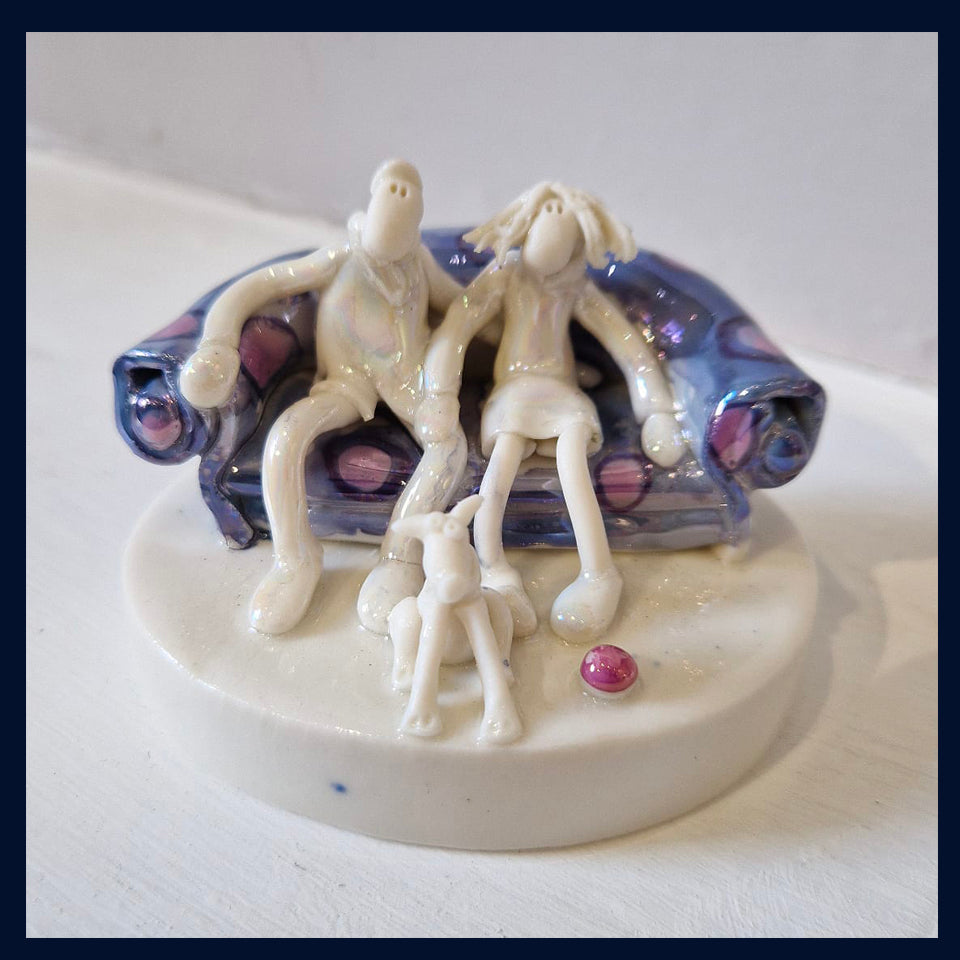 Ceramic Miniaturist Andrew Bull - couple sat on a sofa with dog