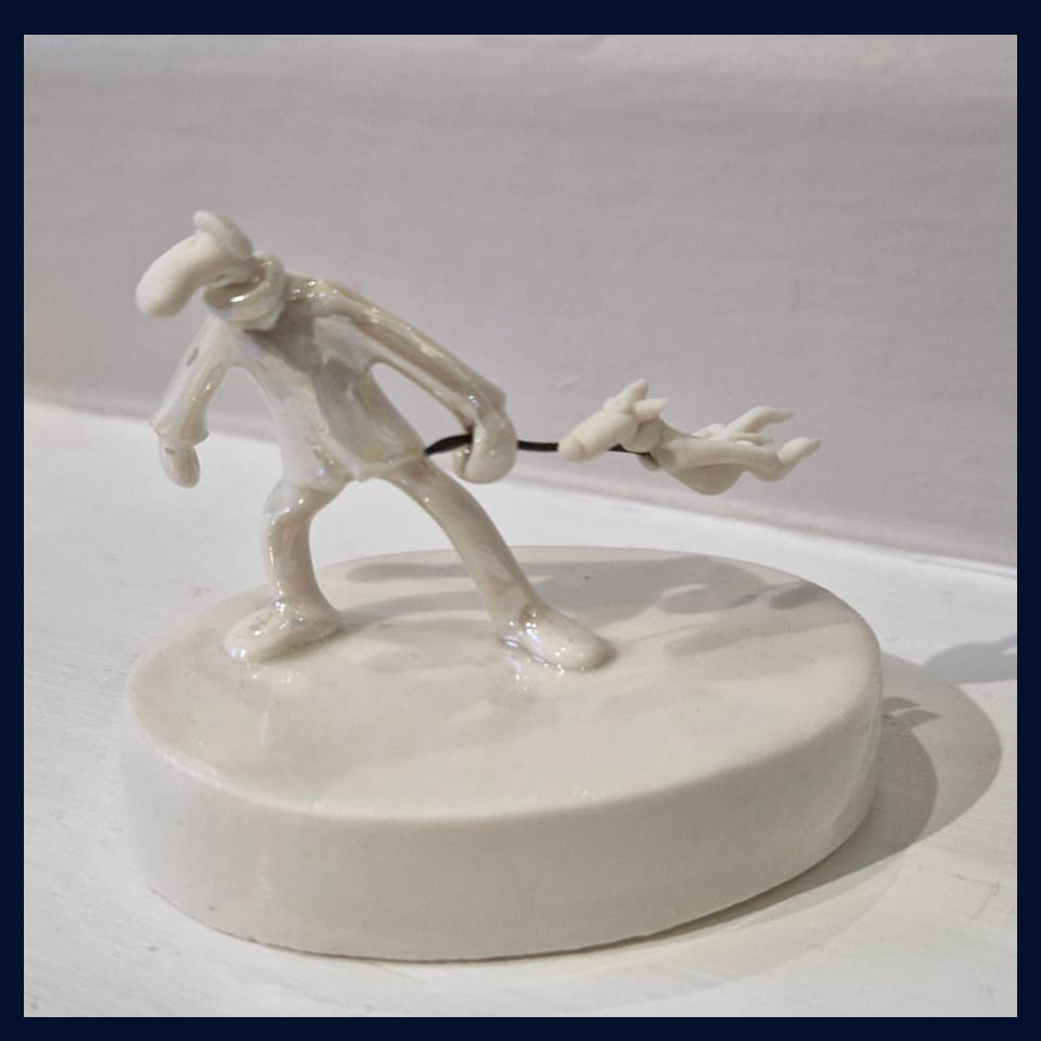 Ceramic Miniaturist Andrew Bull - man walking the dog on a windy day